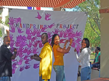 Two men and women giving their handprints.