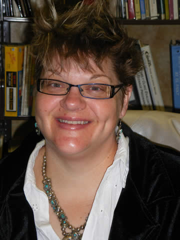 A young bespecled woman with short hair.