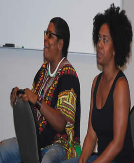 Two women sitting in chairs.